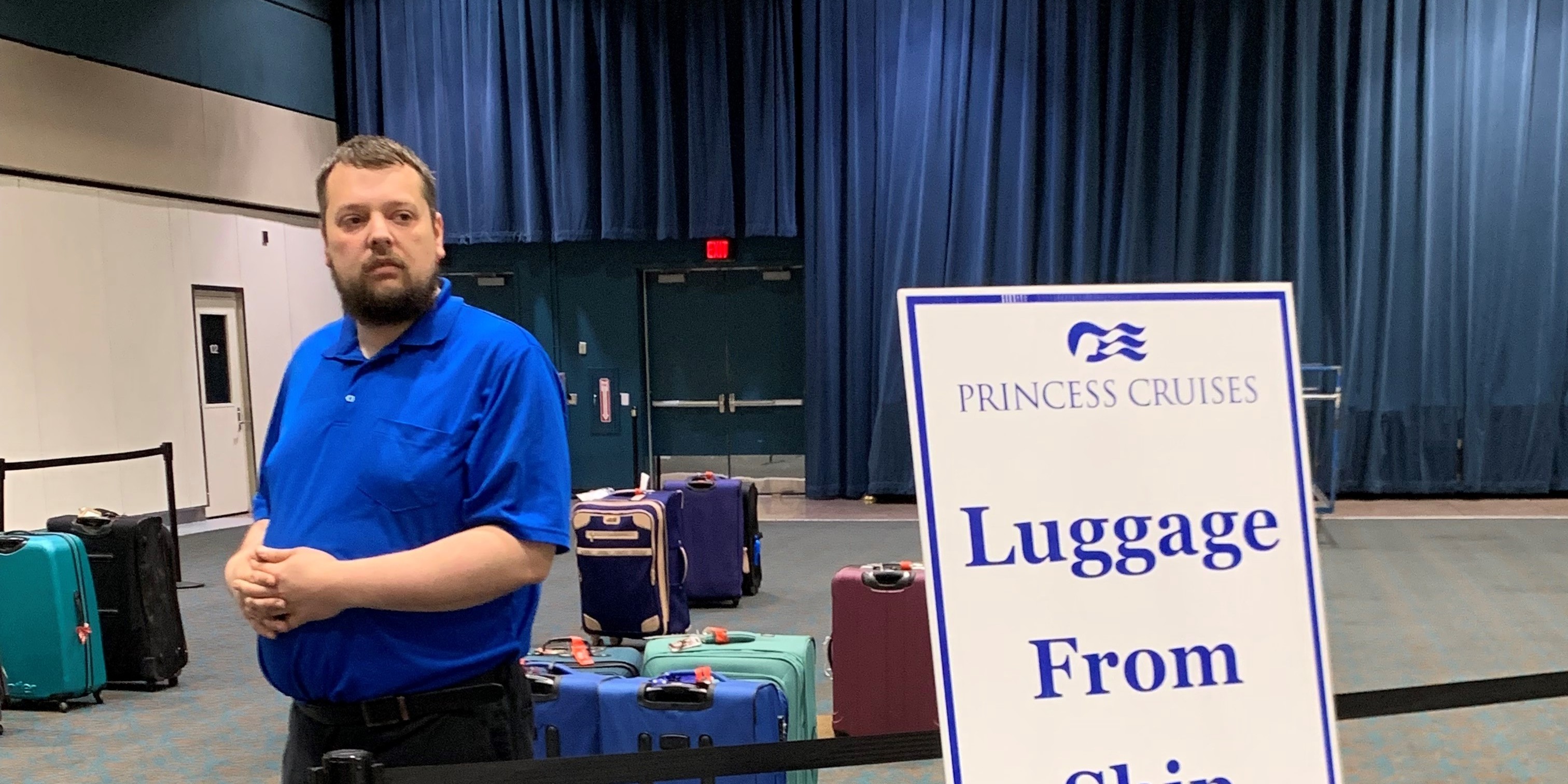 Man stands next to luggage