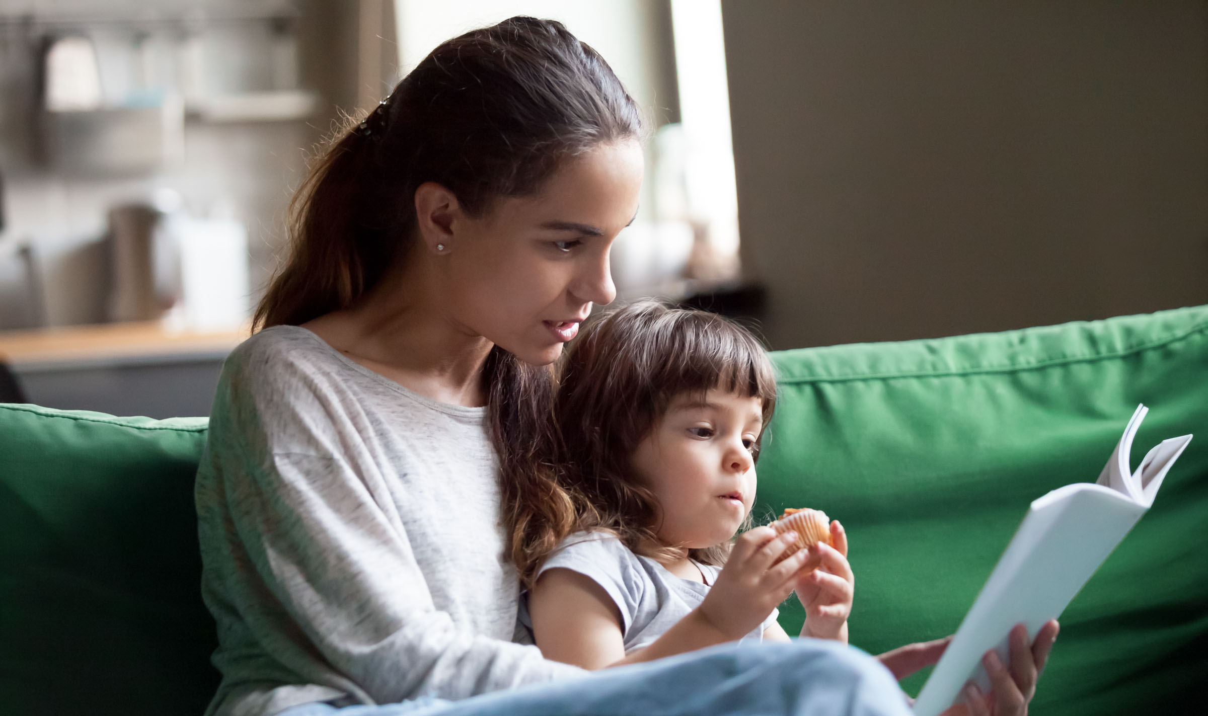 mother and child sitting on couch