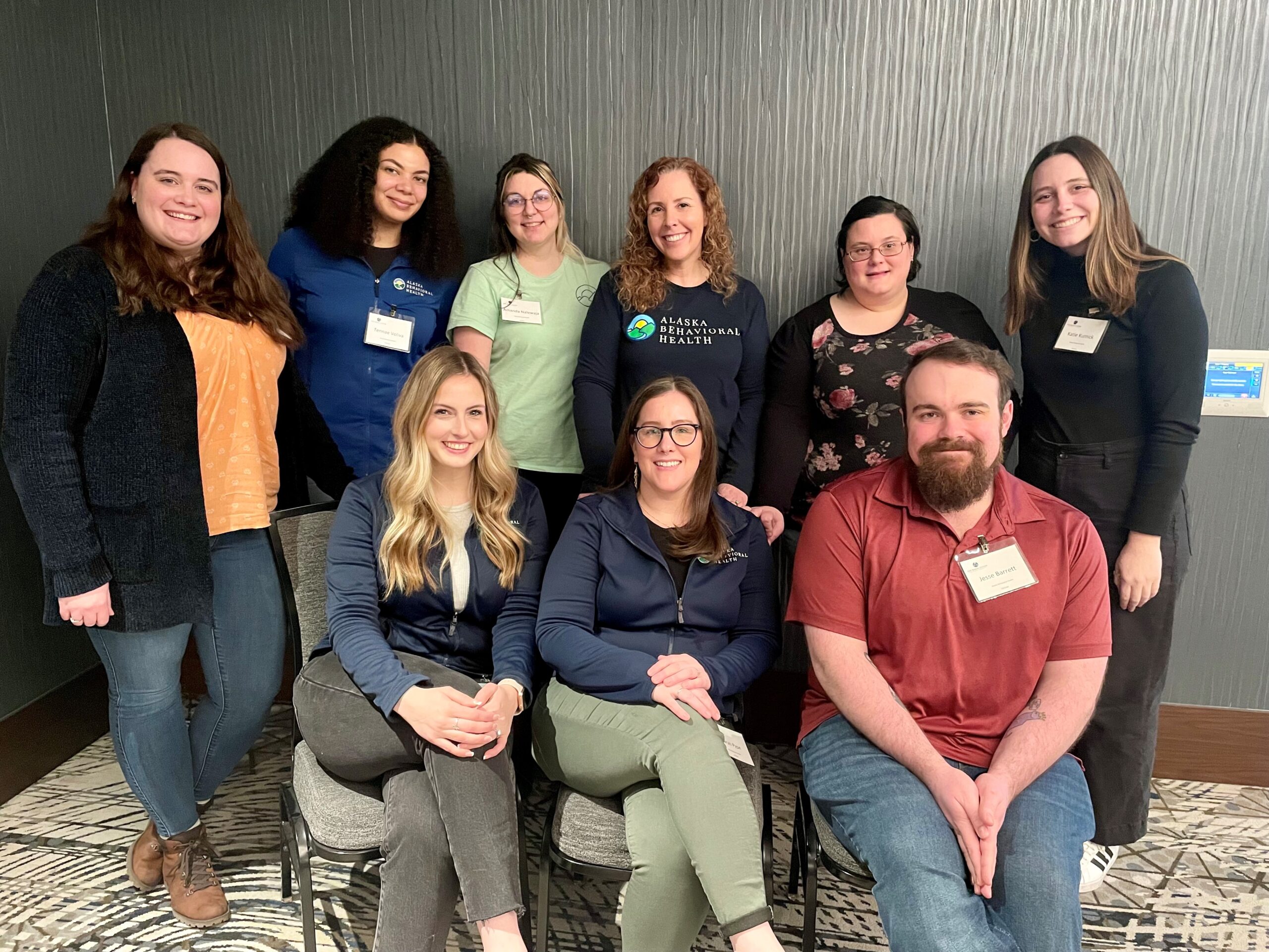 a group of 9 people wearing name tages